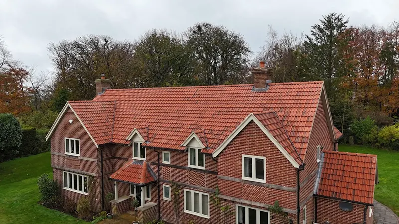 New clay tile pitched roof on a detached brick house in Wiltshire by JK Roofing